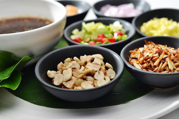 Thai Food wrapped in leaves include many Thai spices are shallots, ginger, chilli, coconut burns, lemon and Ayesha rocket leaves eat with chilli sauce tamarind together