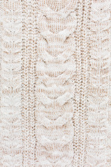 Beige knitted wool texture pattern.