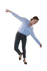 Female executive balancing while waking against white background