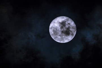 Fototapeta na wymiar Thin cloud flowing over shiny moon - Super Moon