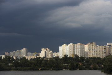 Fototapeta premium Heavy, stormy clouds of contrasting color over the evening city