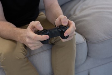 Man playing video game against white background