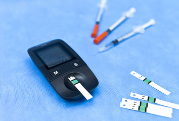 Small blood glucose meter, test strips, and insulin syringes for patients with diabetes mellitus 