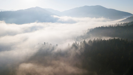 Fototapeta premium Aerial view of the mountains with a morning fog