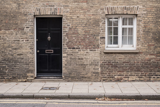 A Row of Brick Buildings with Black Doors on a Street in London Stock Image  - Image of architecture, english: 189002149