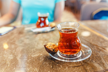 Two turkish tea in traditional glasses on cafe table