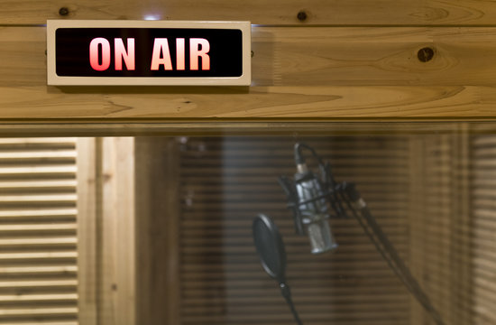 Microphone with wind shield in the On-air studio room - Powered by Adobe