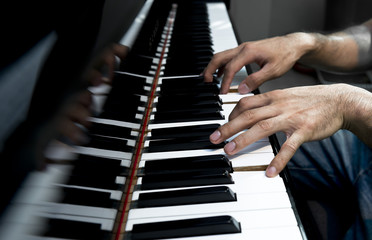 Obraz na płótnie Canvas musician plays old grand piano
