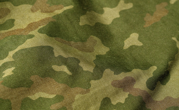 Green and brown color military uniform pattern with blur effect.