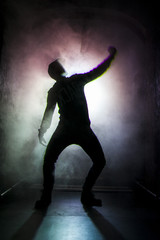 Fototapeta na wymiar Silhouette of a dancer man in the light