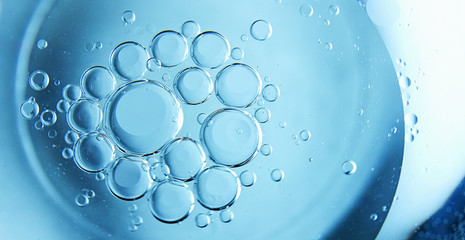 Blue drops and bubbles of clear water, blue abstract water background.