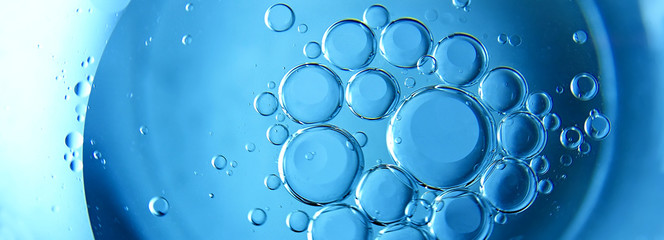 Blue drops and bubbles of clear water, blue abstract water background.