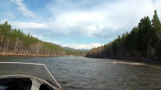 Airboat airglider on mountain river Temnik. Clean water and stone rock bottom in spring. Border of Baikal State Nature Biosphere Reserve. Ecotourism in Siberia of Russia.