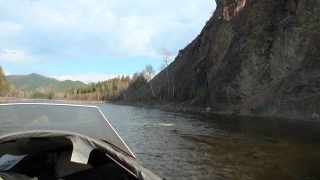 Airboat airglider on mountain river Temnik. Clean water and stone rock bottom in spring. Border of Baikal State Nature Biosphere Reserve. Ecotourism in Siberia of Russia.
