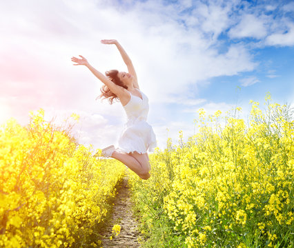 Jumping Woman In Yellow Field