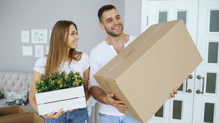 Young happy couple talking while standing at their new house