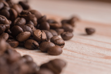 Coffee beans on wooden table close up. Place for text or design.