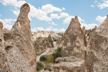 Beautiful view of the hills of Cappadocia. One of the sights of Turkey. A blue sky with clouds in the background.