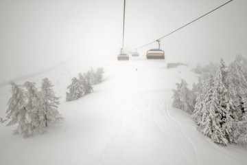 Fog and snowfall on ski resort