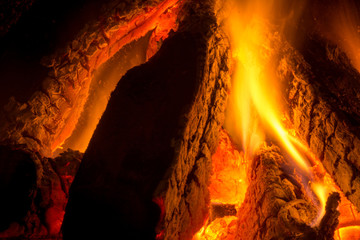 Close Up Of Burning Wood Pieces In a Fireplace