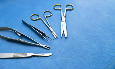 Basic surgical instruments on the sterilized blue wrap