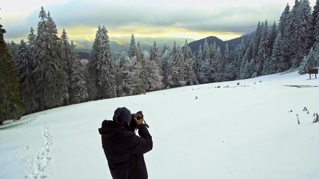 photographer photographing winter panorama
