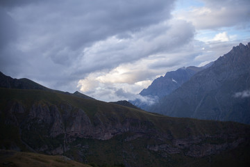 Fototapeta premium ountain panoramic view on a evening. Beautiful evening mountain landscape under bright sunset. Georgia Kazbegi