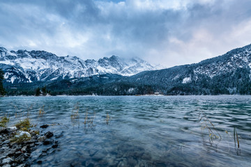 Fototapeta na wymiar View of the famous Eibsee with alpine mountains in the background