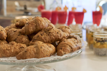 Glass plate full of integral mini croissants.