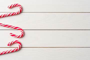 Candy cane on an old white wooden table