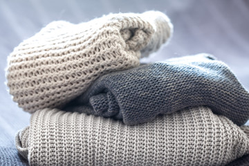 Obraz na płótnie Canvas beautiful knitted clothes, neatly folded, close-up, handmade sweaters.
