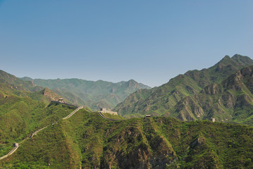 Great wall of China built on the mountain top with hundreds of tourists going up