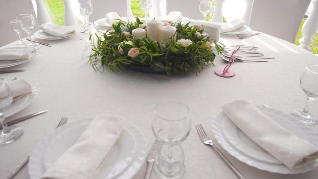 Banquet decorated table, with cutlery. Wedding decor in the banquet hall.Serving of a festive table, plate, napkin, knife, fork. Table setting decoration. Romantic Dinner or other events.