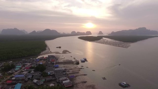 Bansamchong fishing village in Phang Nga province inside pine forest in front of village have pier for transport to Andaman sea. cultured mussels near the pier of fishing village can see when low tide