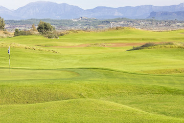 Obraz premium Golf course in Belek. Green grass on a field. Blue sky, sunny day
