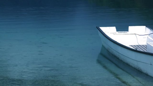 Fishing boat on lake during summer rain