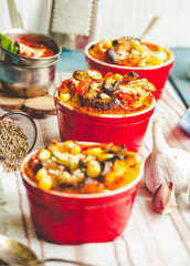 Portioned casserole.from corn grits, eggplant and tomato sauce. Vegetarian gluten free dinner. Selective focus.