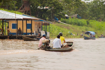 People leaving the village of Leticia by boat over the amazon river