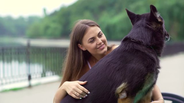 Girl with a dog in the park. German Shepherd with a woman in the nature.