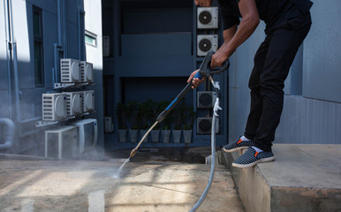 The man cleaning with high pressure water jet.