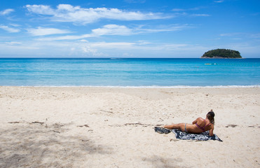 Fototapeta na wymiar Woman sunbathe at the beach.
