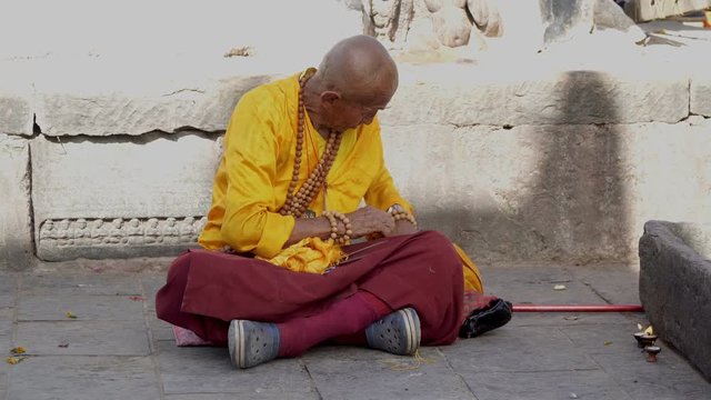 The Old Monk Prepares for Prayer Near the Buddhist Temple. Nepal