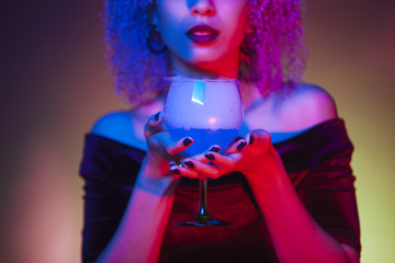 close up of an alcoholic blue mystery drink with iced cold smoke