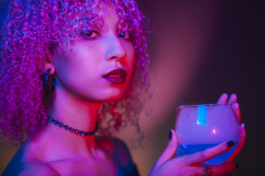 sexy afro american woman holding a blue spirit drink