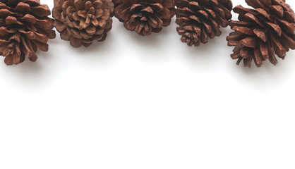 The pine cones are placed on a white background in the left corner ,frame for Christmas and happy new year celebration party