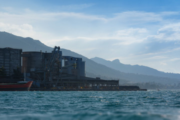 Large Factory on Shore at Sunset