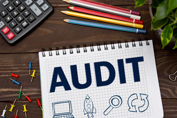 Notebook with a Business notes AUDIT on the office table with tools. Concept AUDIT with elements of...