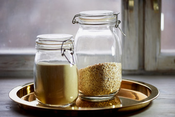 Banks with dry food on a gold tray. Semolina and oatmeal. Healthy eating. Cereals