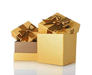 Two golden classic shiny gift boxes with brown satin bows