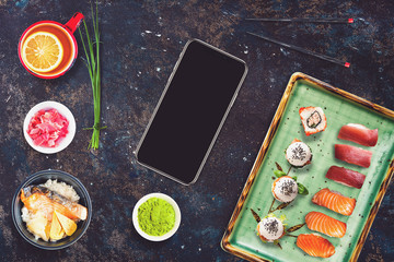 Black smartphone in a sushi bar